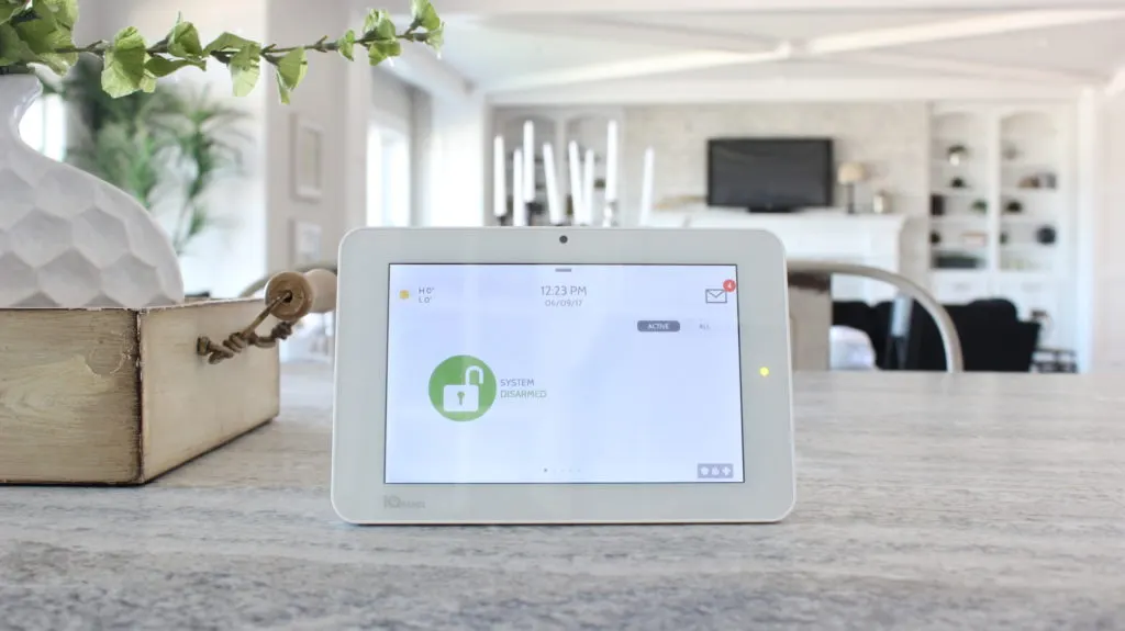 Qolsys touchscreen security panel on a kitchen counter